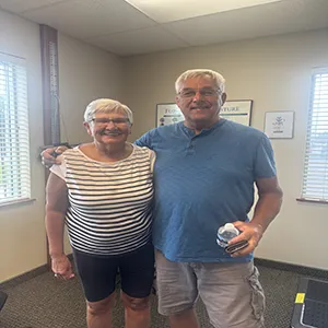 Two older people standing and smiling