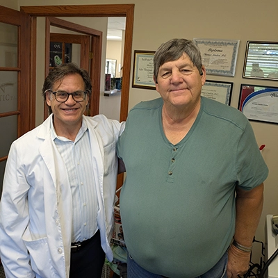 Thomas Linden smiling with a patient.